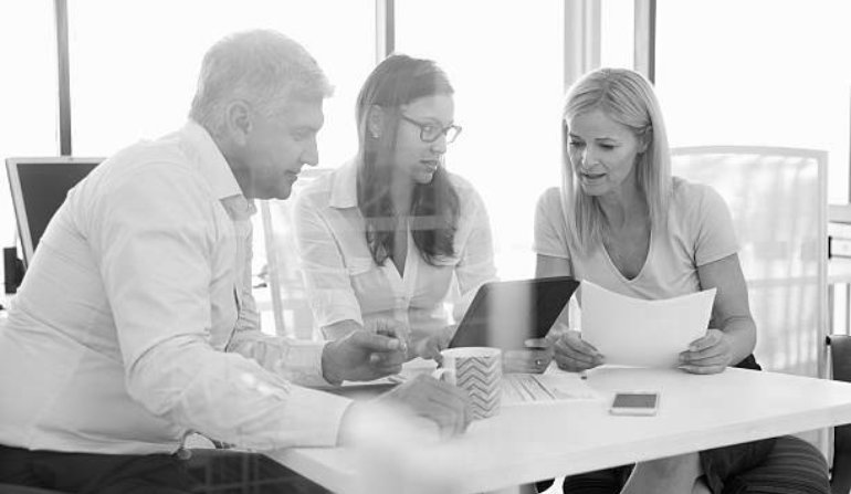 Group of colleagues meeting around a table in an office