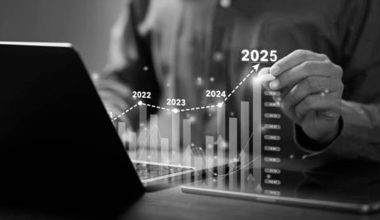 Businessman analyzes the graph of trend market growth in 2025 and plans business growth and profit increase in the year 2025. plan finances of the business